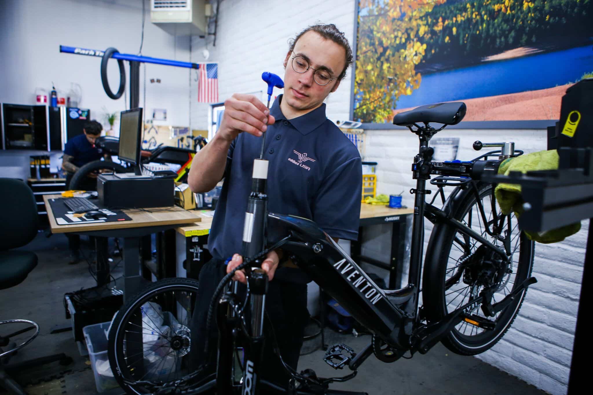 eBikes USA employee expertly fixing an ebike in the service center.